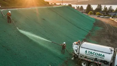 Professional hydroseeding on Tacoma WA hillside for erosion control and slope stabilization landscaping